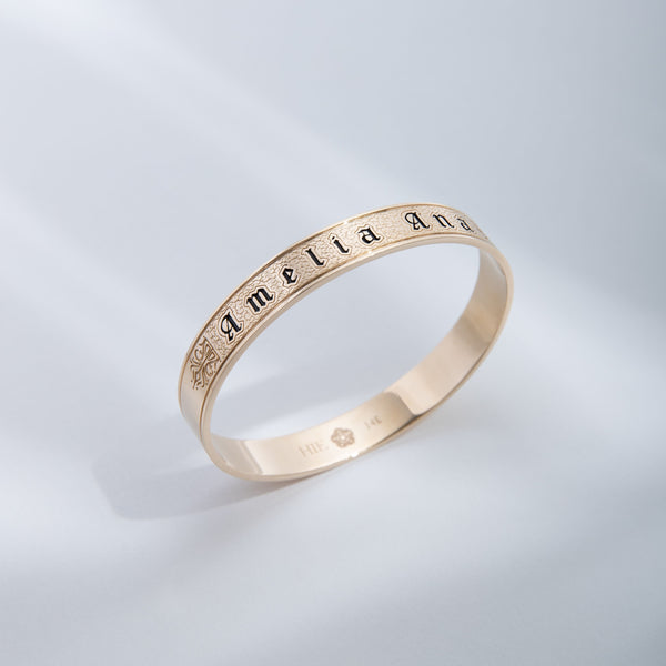 Hie Amelia Ana bangle bracelet upright in gold with subtle palm leaf shadow