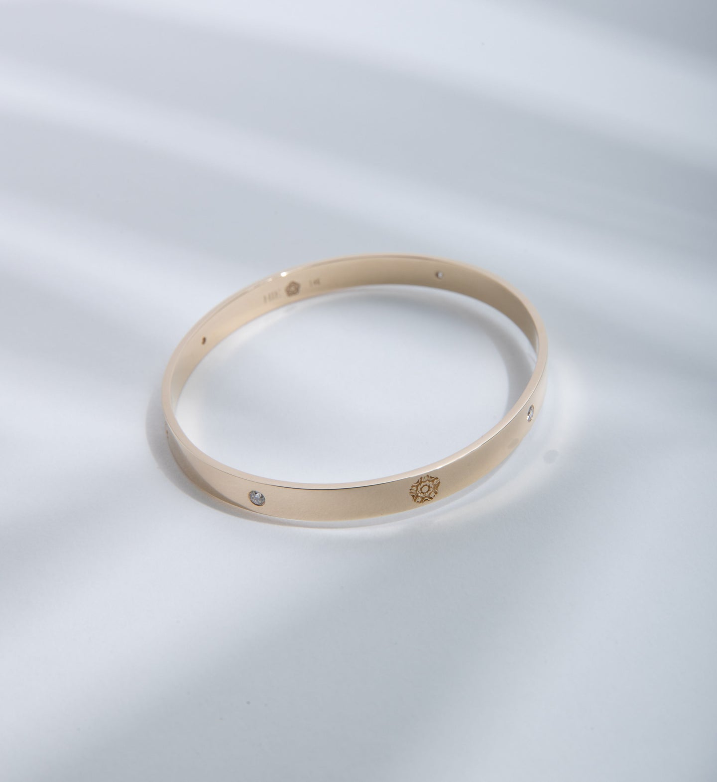 Hie Signature bangle bracelet in gold with logo engraving and diamond details